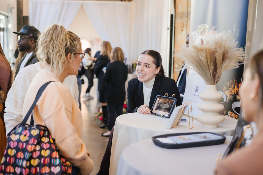 Couple chatting with Venues at Engaged Vancouver wedding show